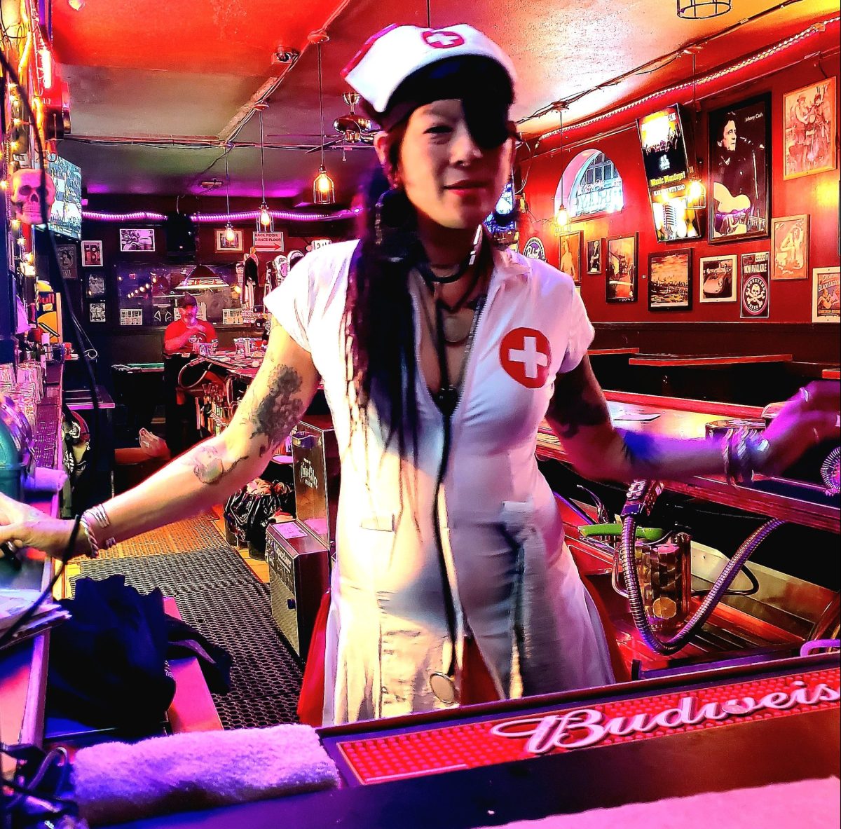 Someone in a nurse uniform at a bar