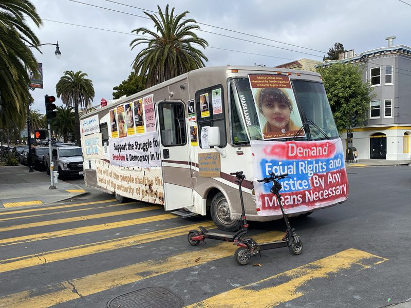 Bus with protest signs about Iran.