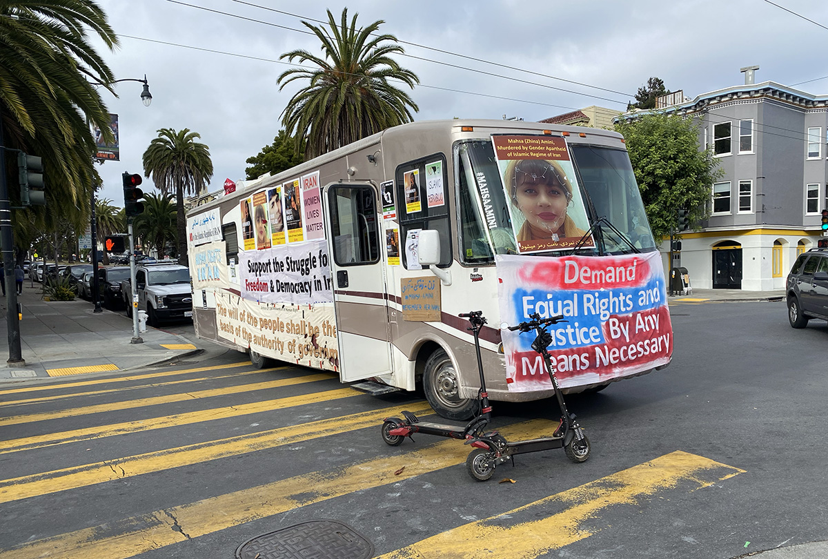 Bus with protest signs about Iran.