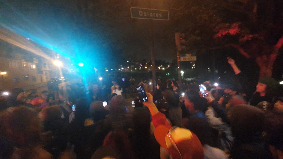 Crowd reacts to fight next to Dolores Park