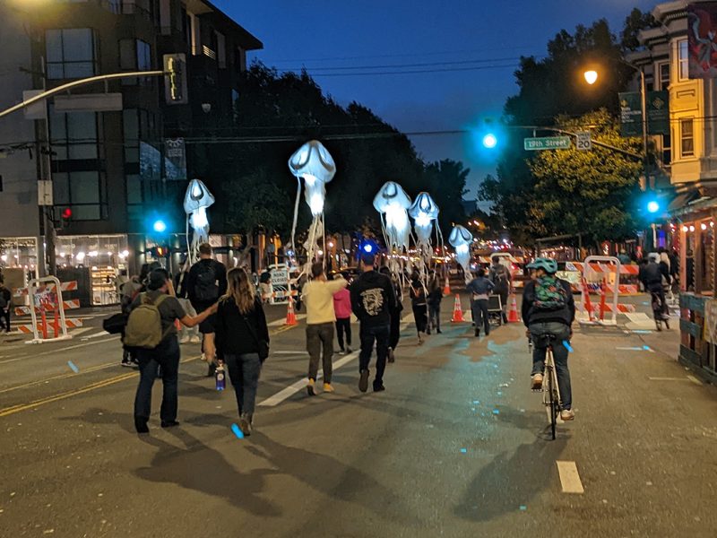 A procession of lights that look like jellyfish