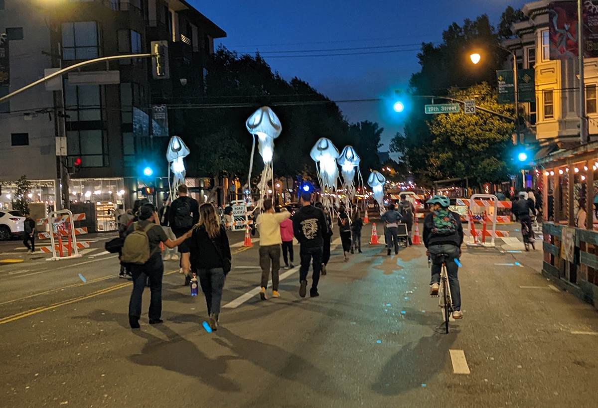 A procession of lights that look like jellyfish