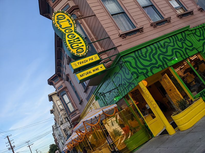Exterior of a yellow and green building.