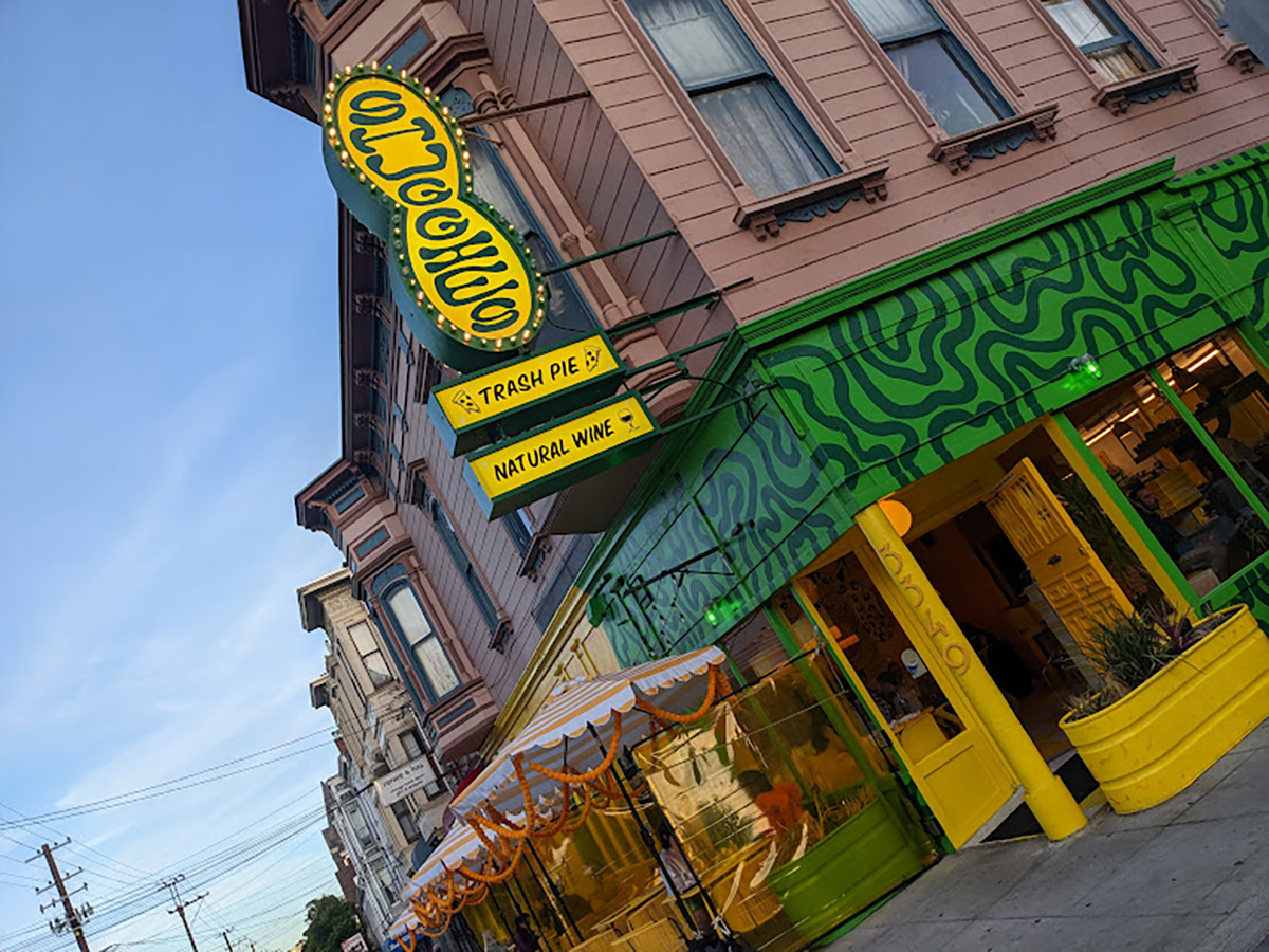 Exterior of a yellow and green building.