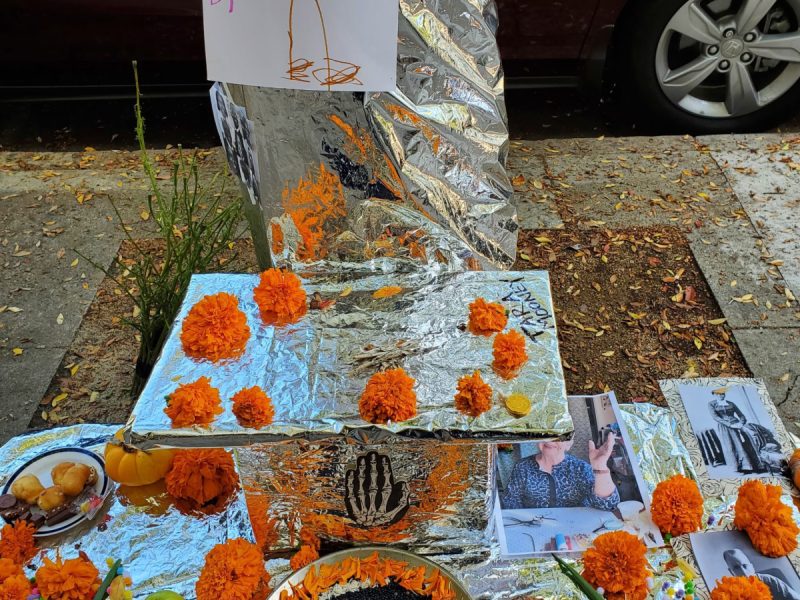 An altar in front of a post with marigolds.