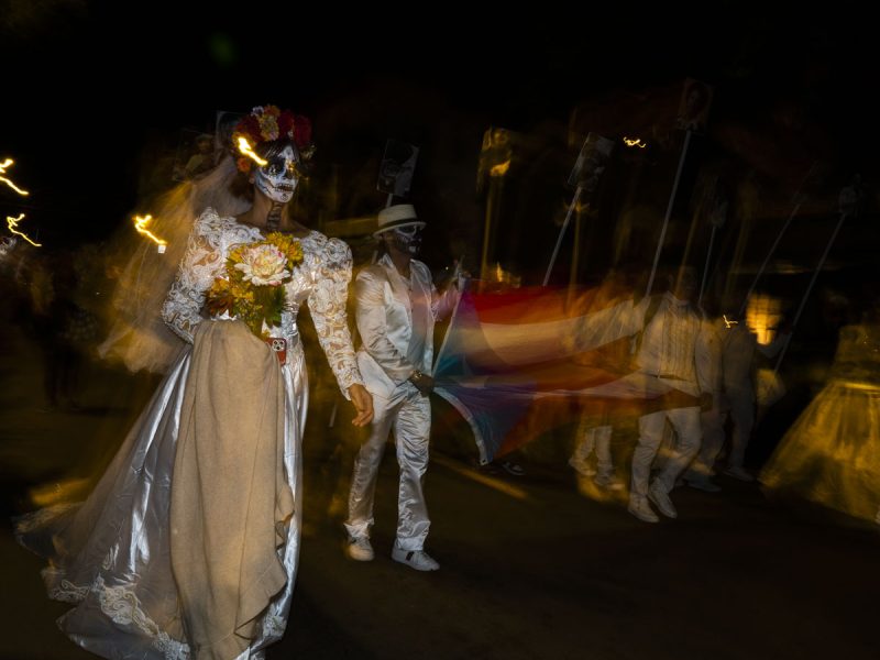 A couple dressed in Day of the Dead realia.