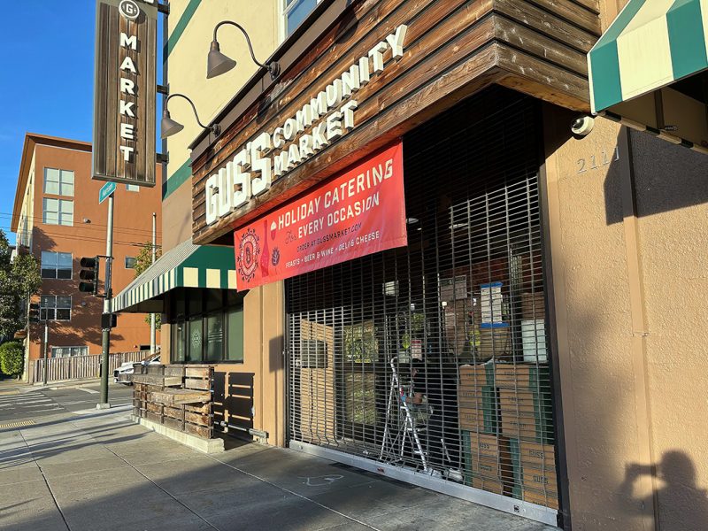 An store front of a market that is clearly closed.