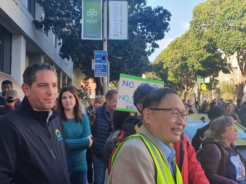 Superintendent Dr.Matt Wayne (left) listens in on the Nov. 2 rally over the EMPowerSF system