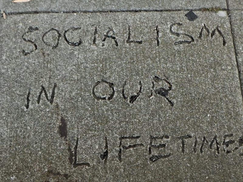 Writing engraved in the sidewalk: "Socialism in our lifetime."