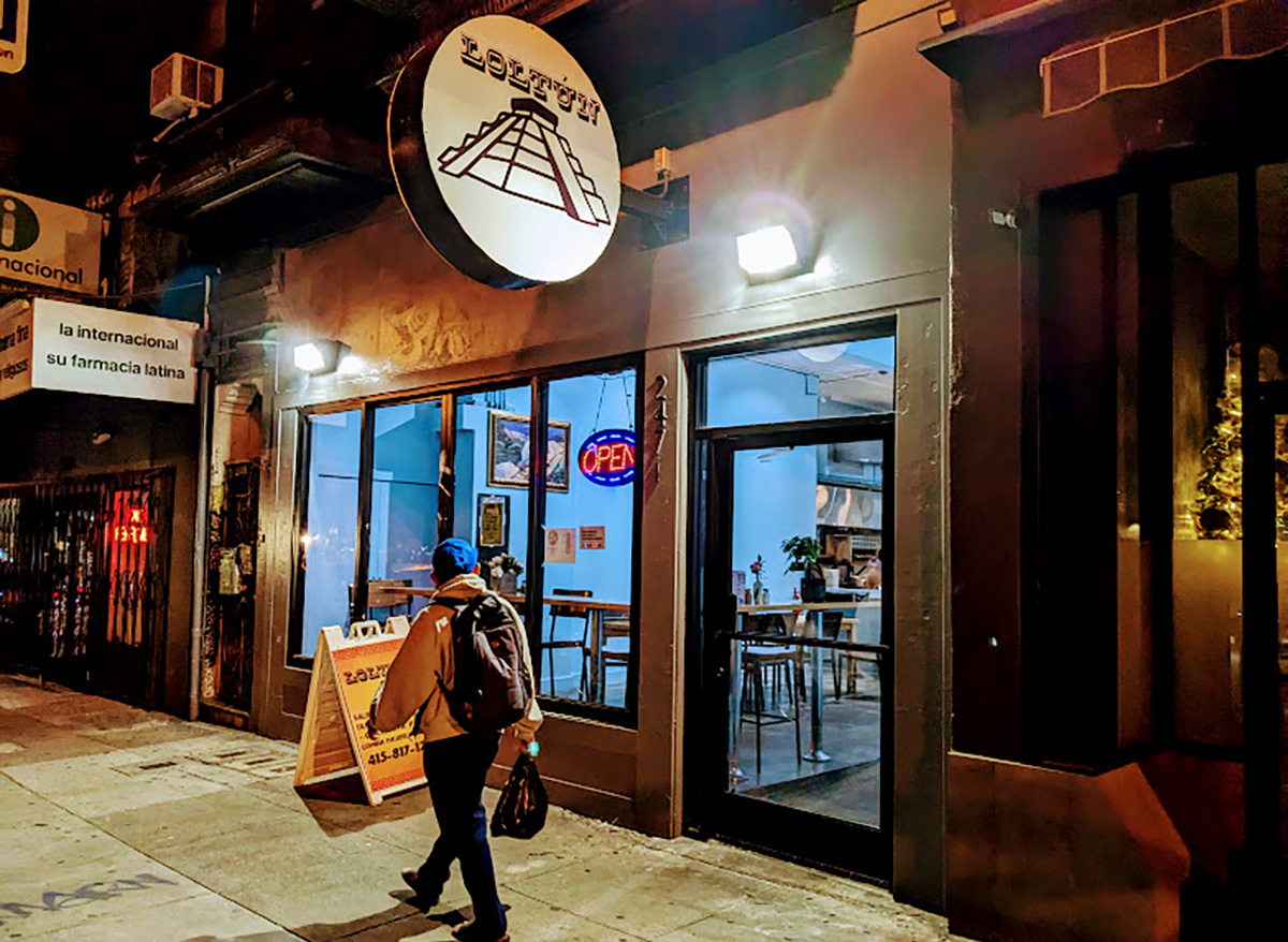 Outside of Loltun with its round signage above.