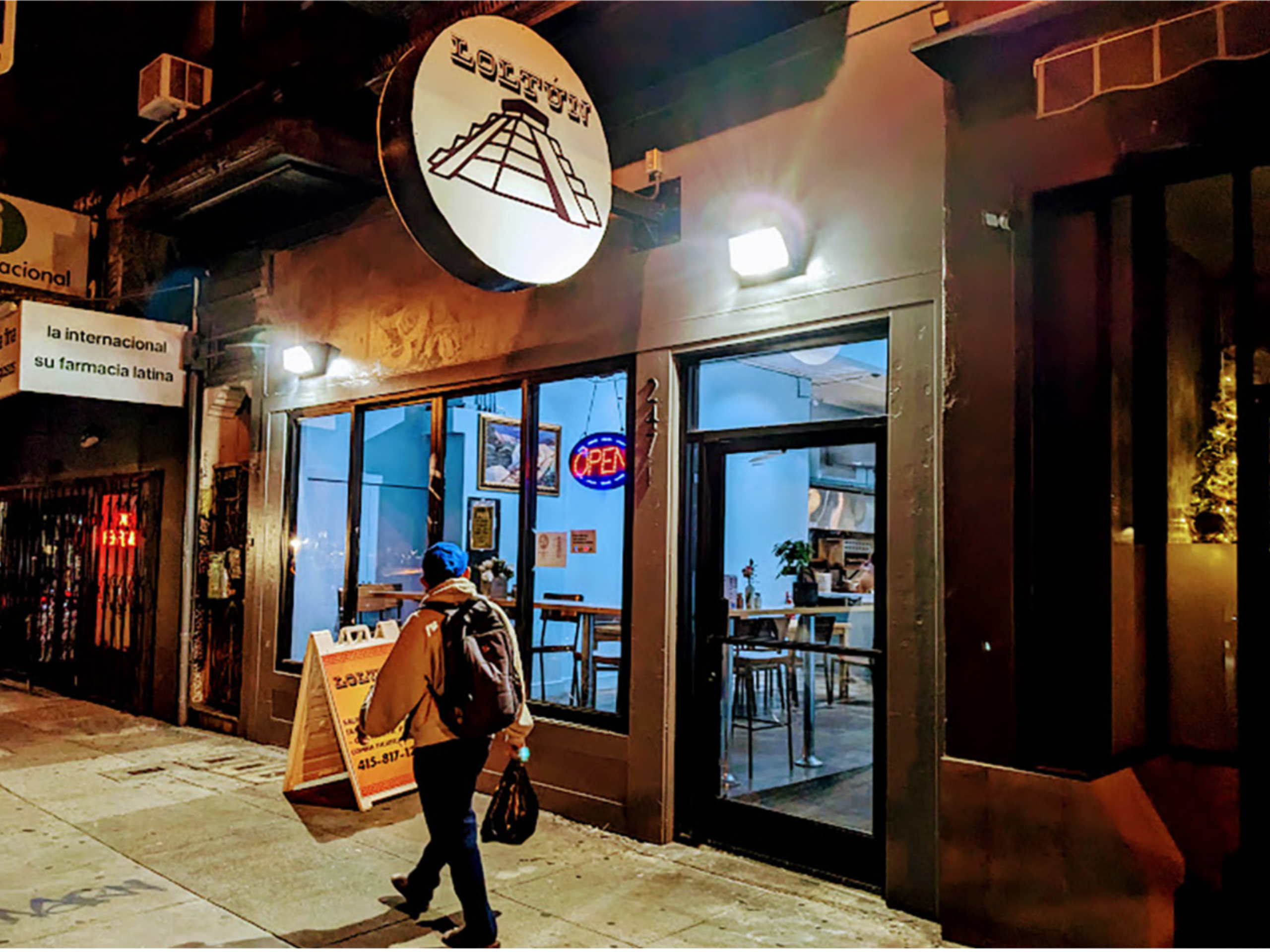 Outside of Loltun with its round signage above.