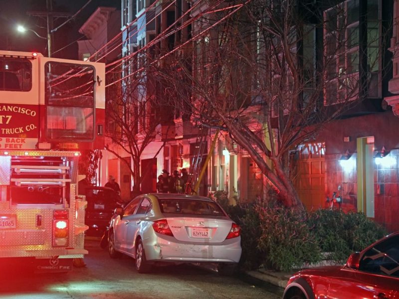 Officers in front of the building where the fire occurred.