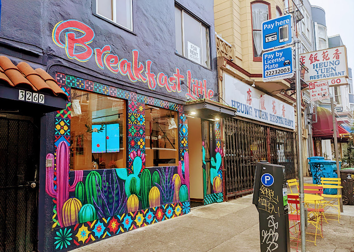 Exterior of a diner with a grey and colored mural.