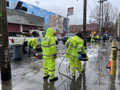 A group of people cleaning the street