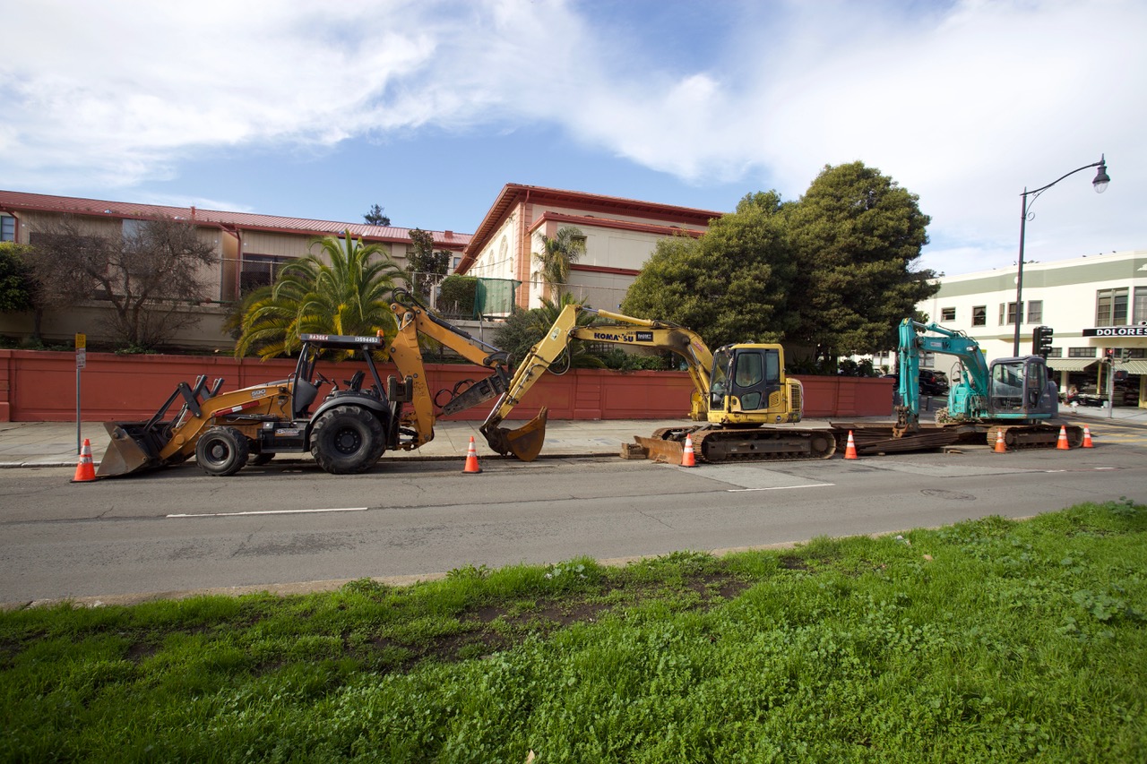 A large power shovel at a construction site with orange cones.