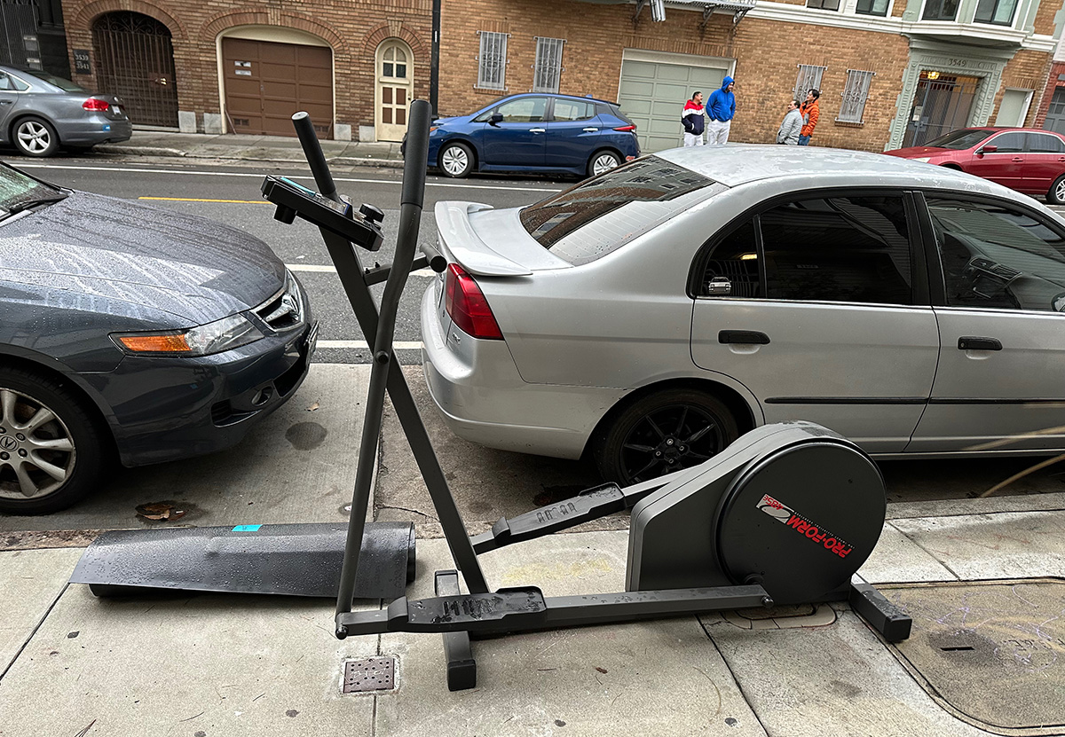 An exercise machine on the sidewalk.
