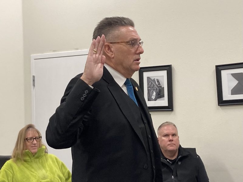 A man raises his right hand