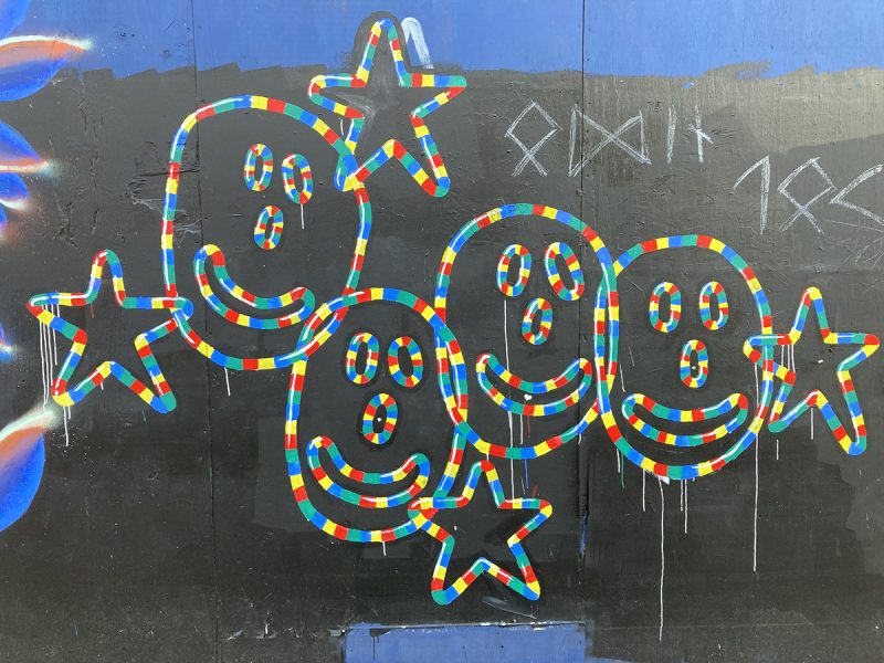 A mural of happy faces