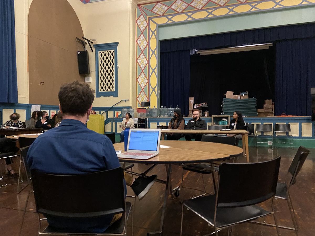 A Buena Vista teacher takes notes at his laptop about the ongoing lead testing discussion in the auditorium.