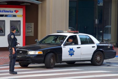 Two police officers and a squad car.
