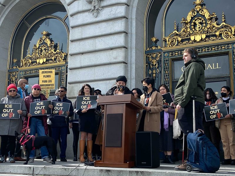 Officials in front of City HAll behind a podium