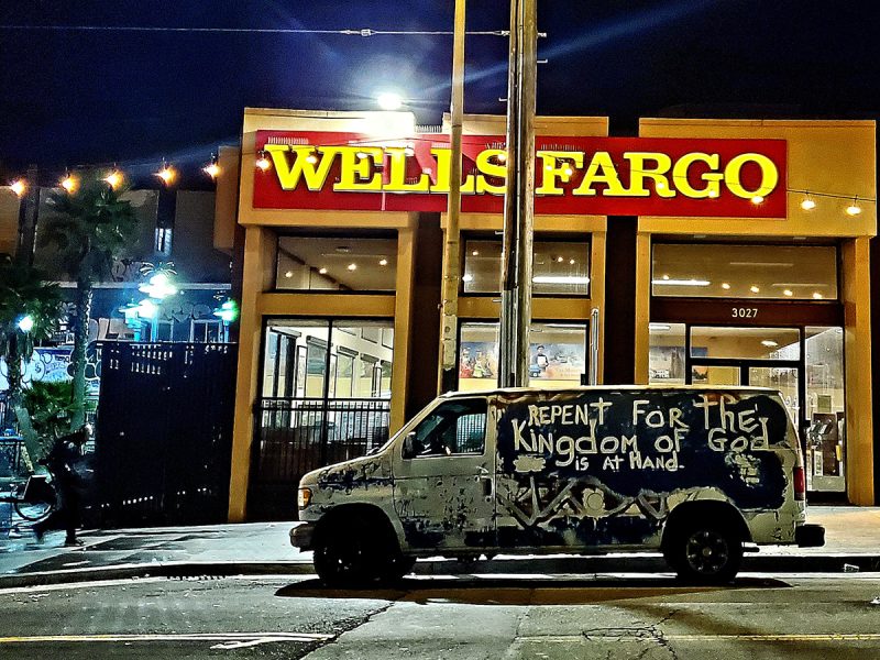 A delivery truck with the word Repent written on it parked in front of a Wells Fargo Branch.
