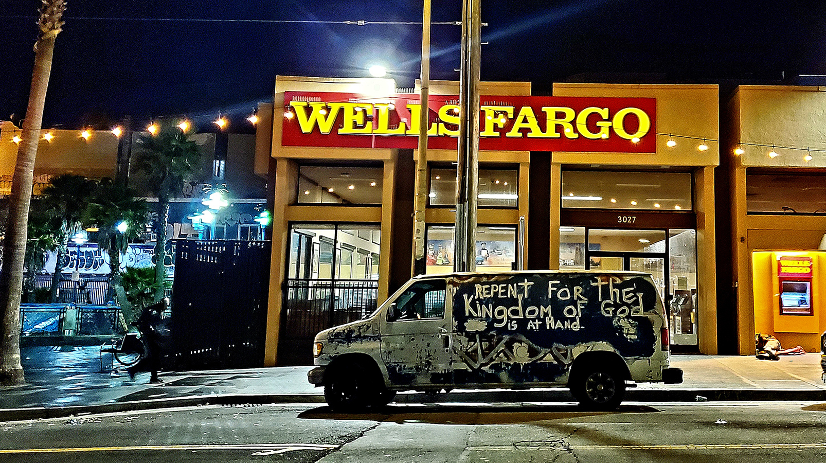 A delivery truck with the word Repent written on it parked in front of a Wells Fargo Branch.