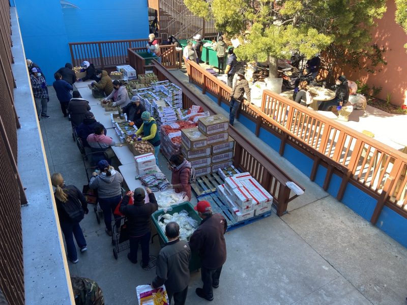 Volunteers at a courtyard in St. Mary's and Martha's Church are setting up a food pantry.