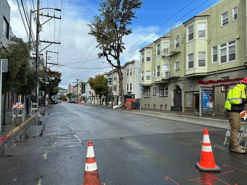 A street blocked with traffic cones.