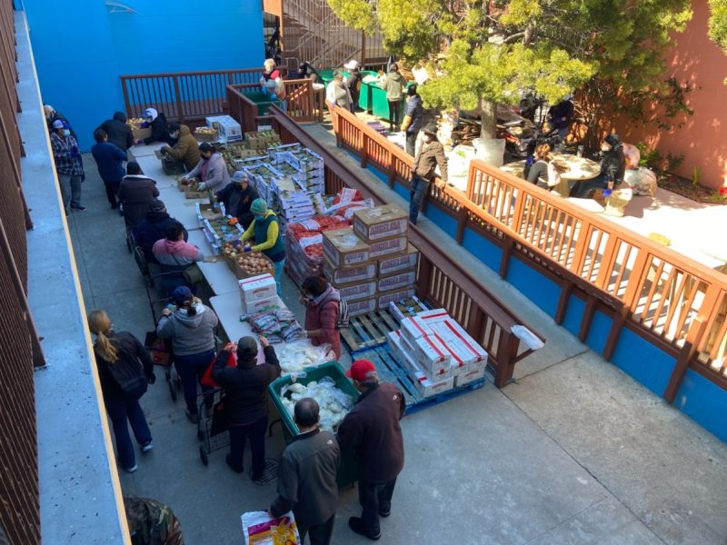 Volunteers at a courtyard in St. Mary's and Martha's Church are setting up a food pantry