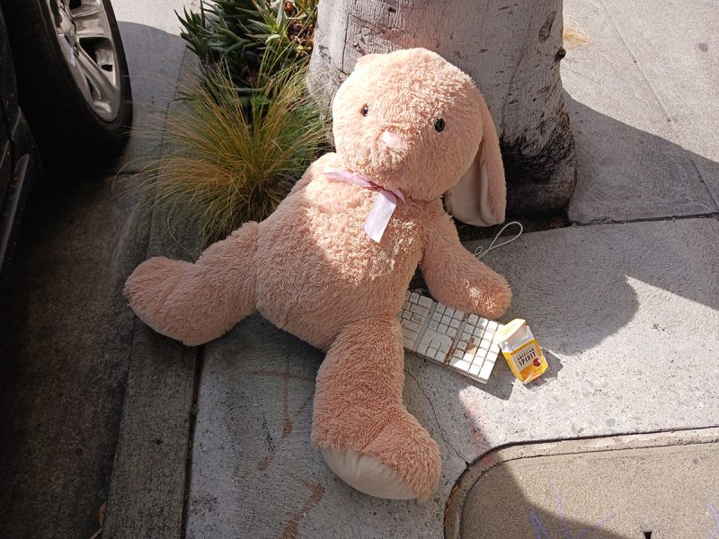 A stuffed animal near an old computer keyboard.
