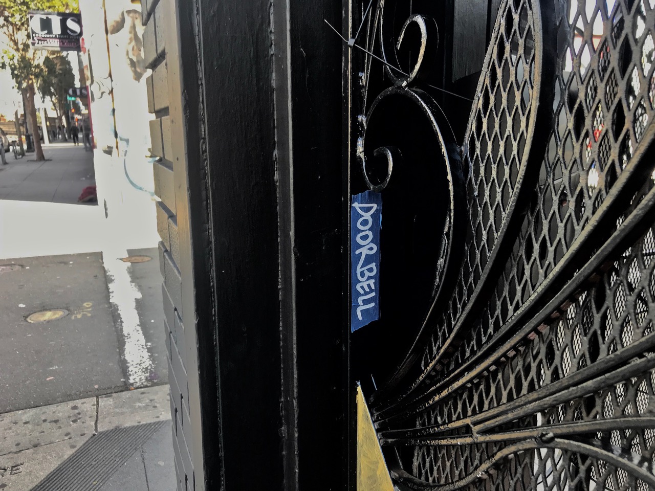 The side of a door with Doorbell written on the side of it.