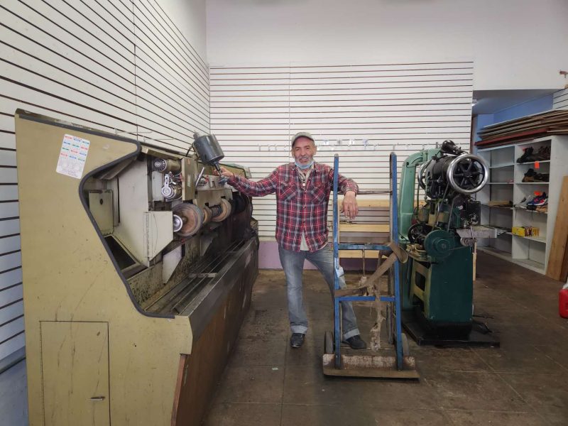 A man standing next to a machine.