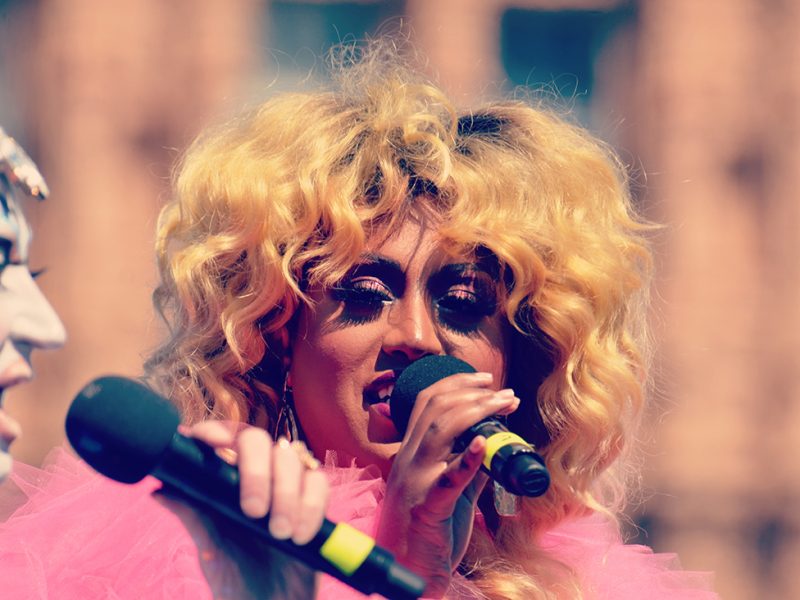 Two people in drag with microphones.