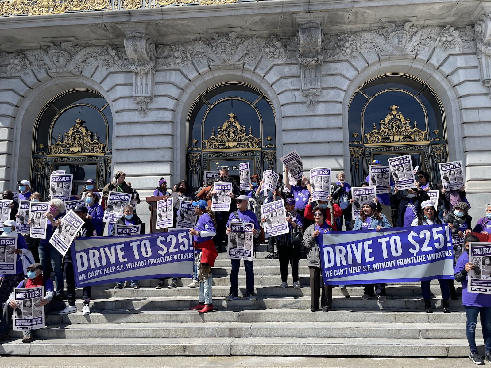 A group of people holding posters.