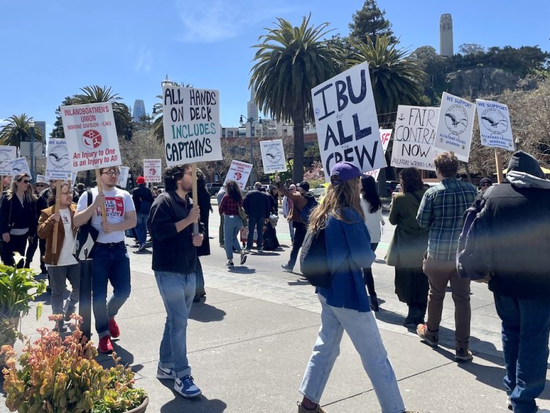 A group of people walking with signs