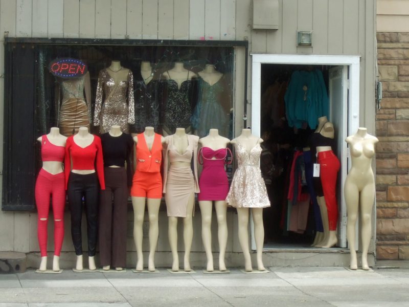 A line of mannequins in women's clothes.