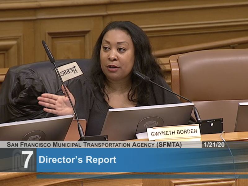 Gwyneth Borden sitting in a chair at an MTA board meeting