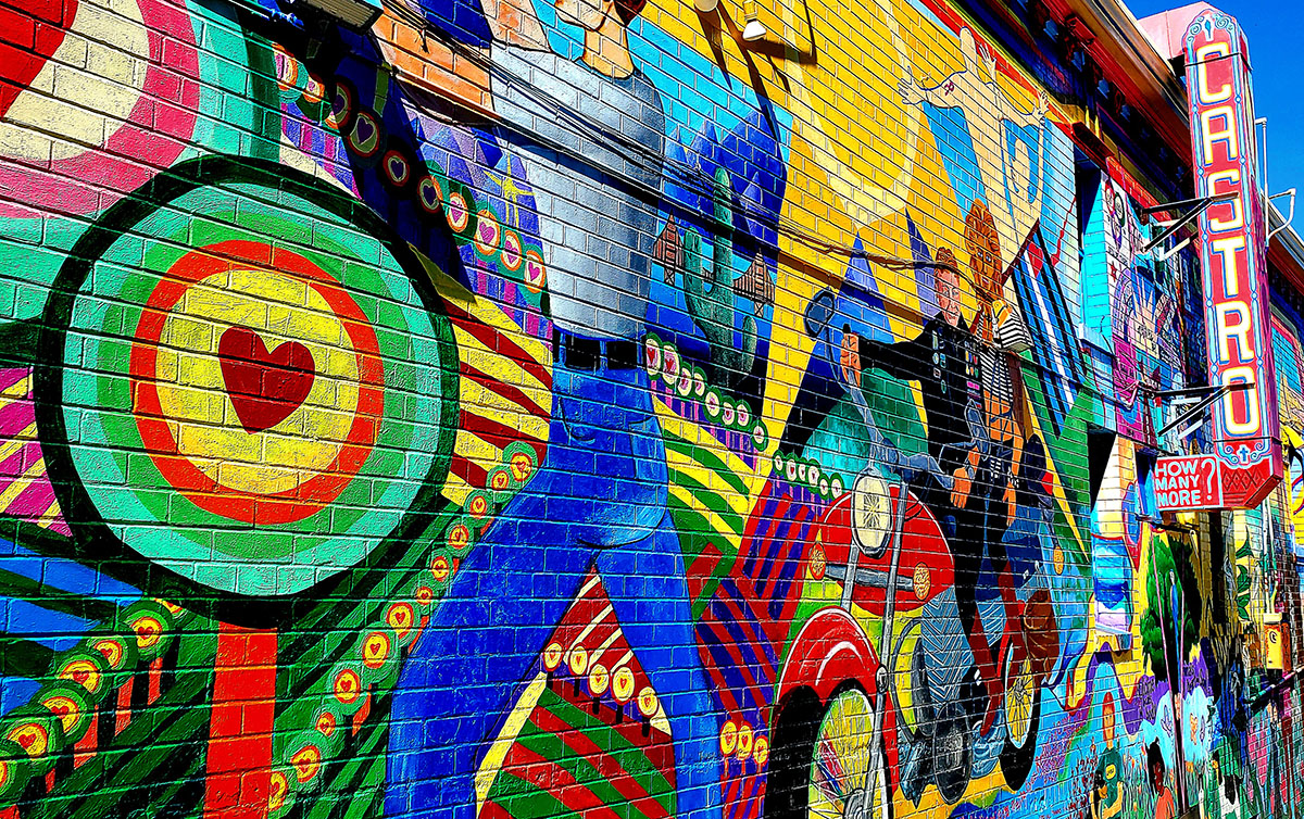 A colorful mural and a neon sign that says Castro.