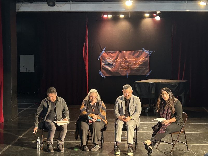 Four people sit in chairs on a stage with the banner San Francisco Latinx Democratic Club behind them.
