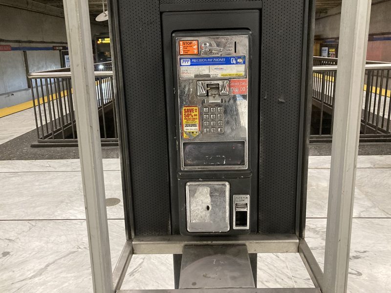 An old phone booth missing the phone.