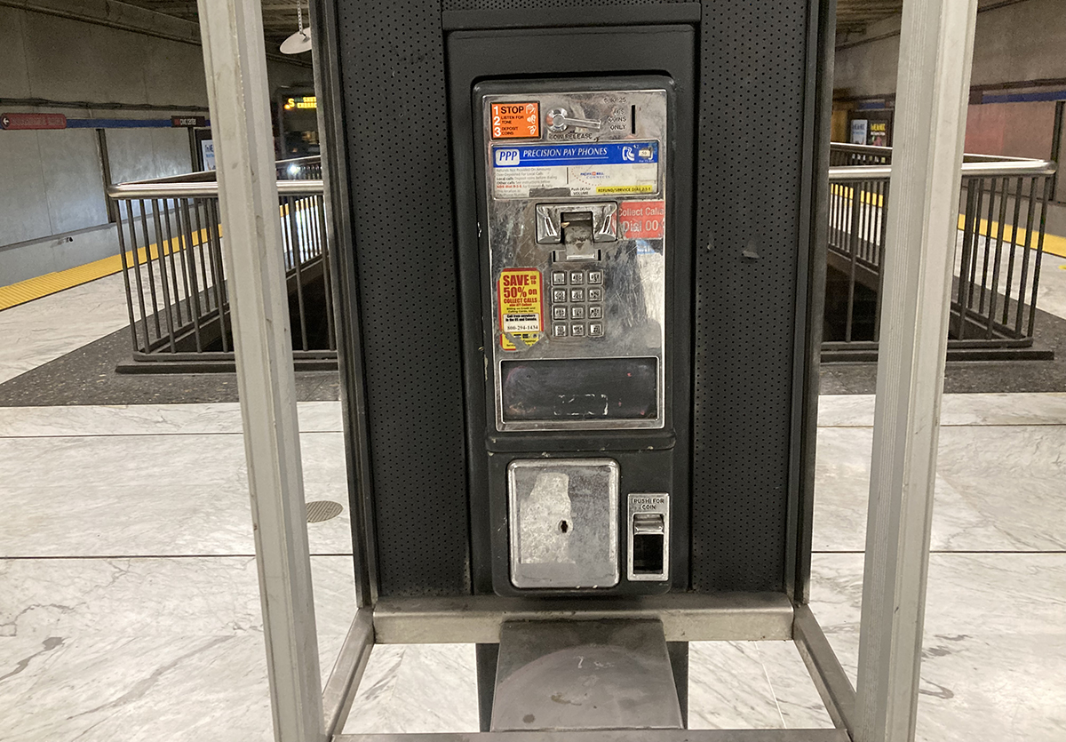 An old phone booth missing the phone.