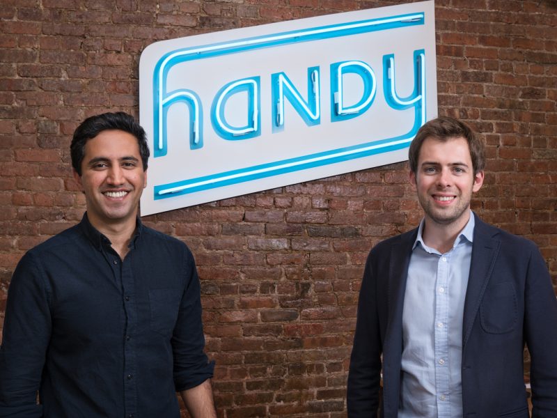 Two people standing in front of a wall