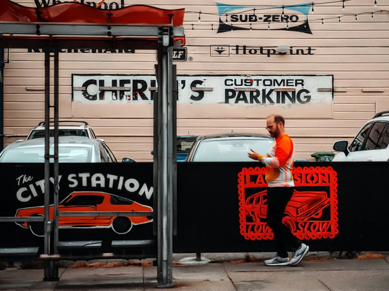 Man walking looking t his hand.