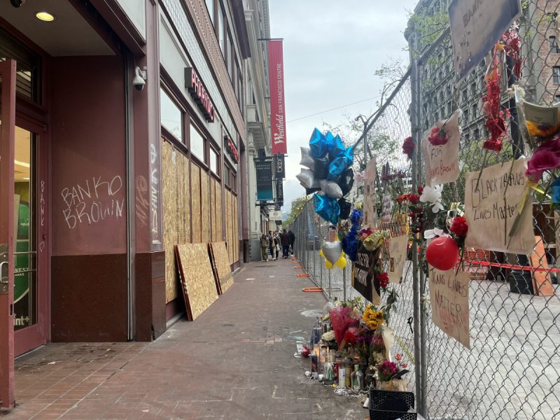Memorial flowers on a chain link fence