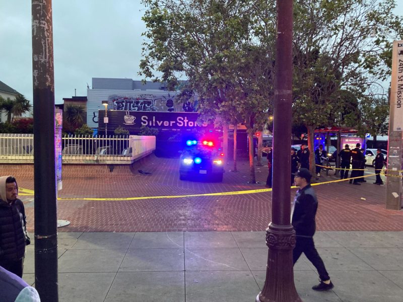 police SUV in BART plaza behind yellow police tap