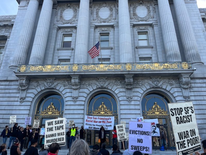 people protest signs city hall