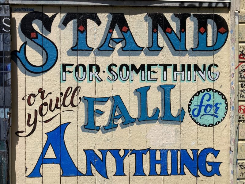 A sign with a motto in script: Stand for something or Fall for anything.