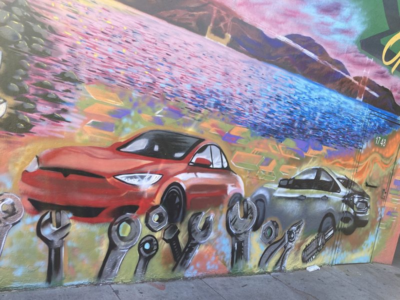 A mural of cars with pliers and other tools along the bottom.