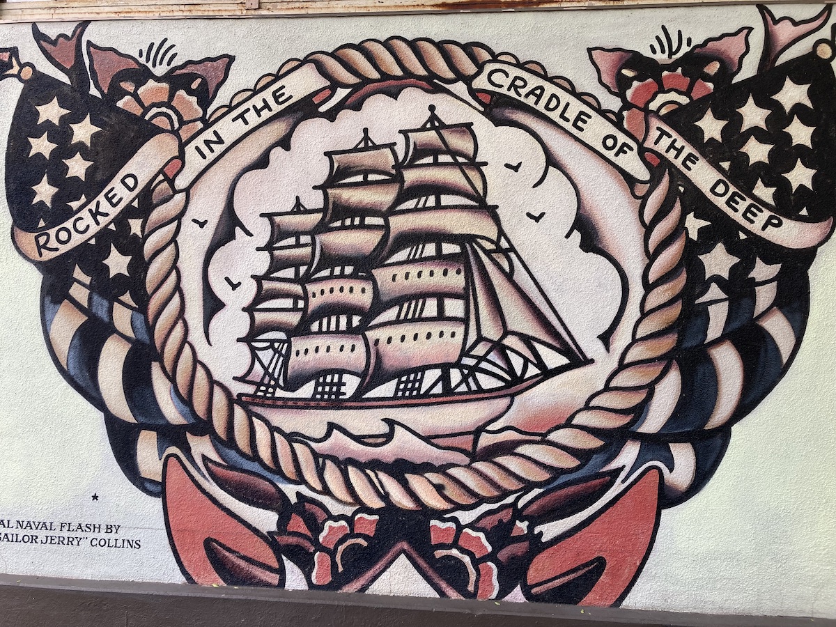 mural of a ship with American flags